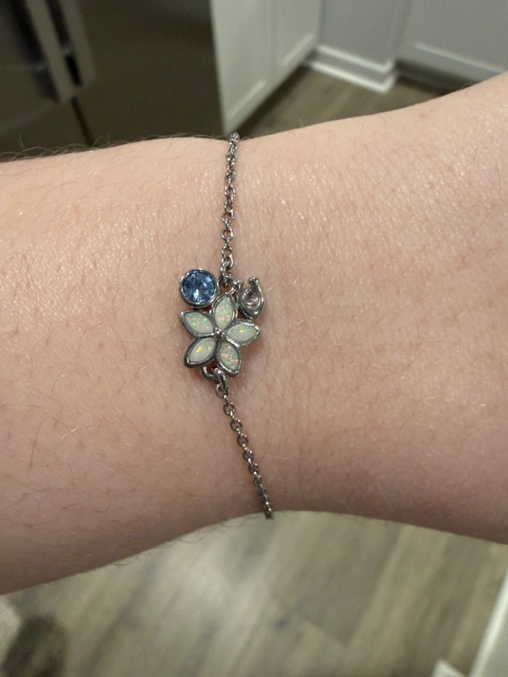 COACH Delicate Silver Flower Charm Bracelet with Blue Accent